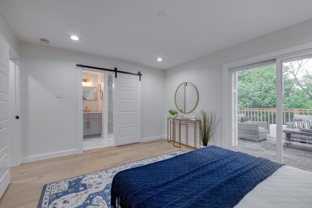 5307 Downs Dr, Austin, TX 78721 - bedroom featuring a barn door, access to outside, light wood-style flooring, baseboards, and recessed lighting