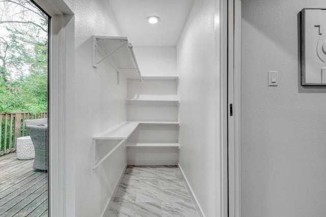 spacious closet with marble finish floor