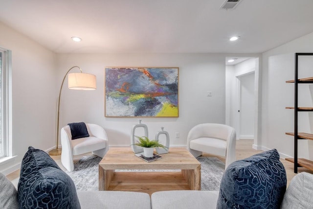 living area featuring baseboards, recessed lighting, and visible vents