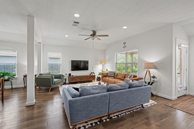 living area featuring a healthy amount of sunlight, ceiling fan, wood-type flooring, and visible vents