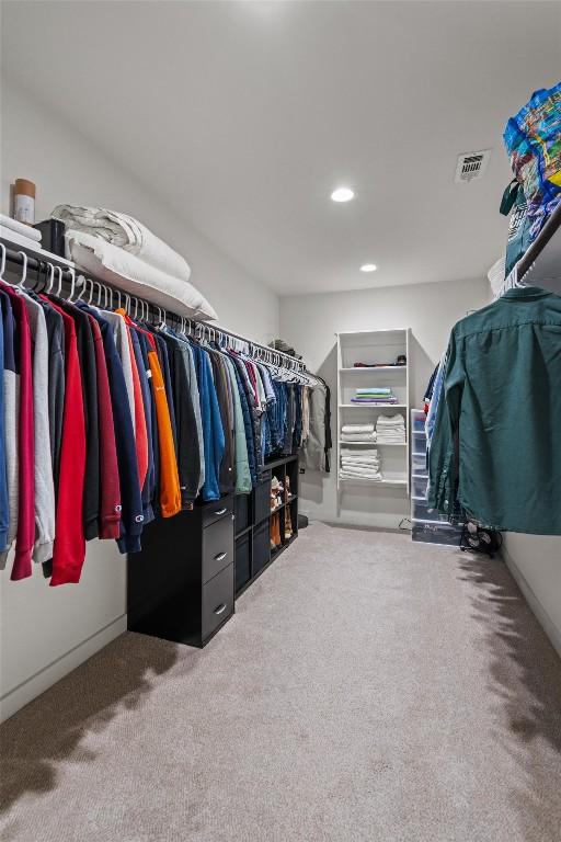 spacious closet with visible vents and carpet