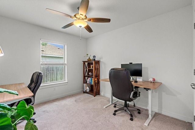 office area featuring carpet floors, baseboards, and a ceiling fan