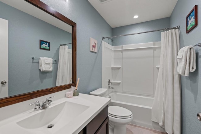 full bathroom with vanity, a textured wall, shower / bathtub combination with curtain, and toilet