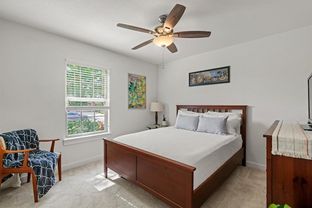 bedroom with baseboards, light carpet, and ceiling fan