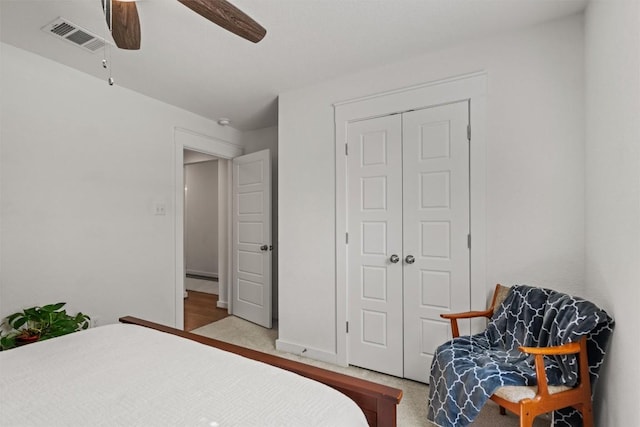 bedroom with carpet, a ceiling fan, a closet, and visible vents