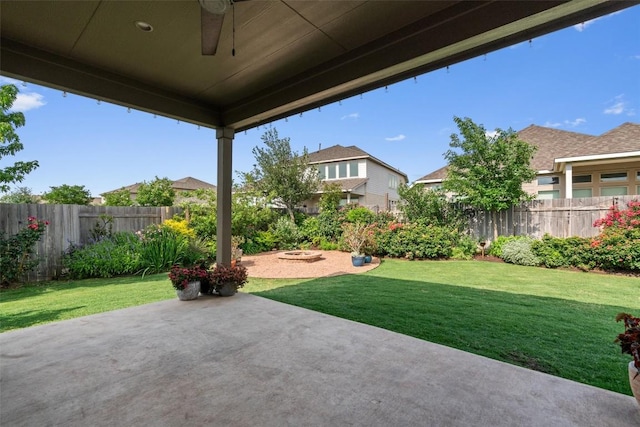 view of yard with a fenced backyard, a ceiling fan, and a patio area
