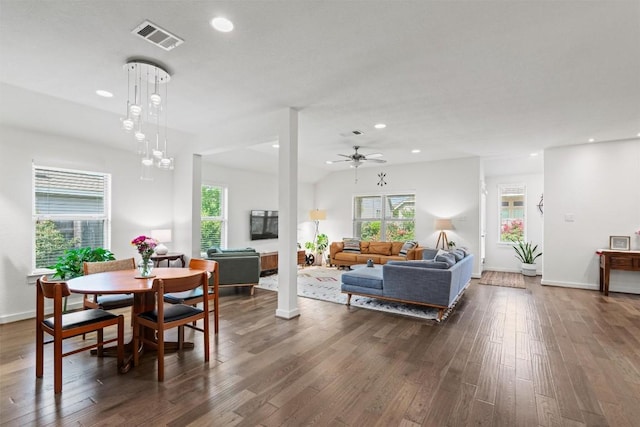 living room with visible vents, dark wood-style flooring, and a healthy amount of sunlight