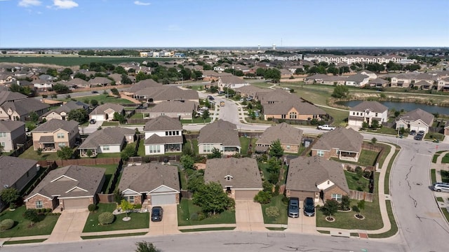 birds eye view of property with a residential view and a water view
