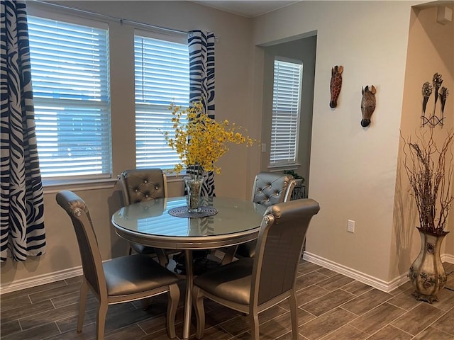 dining area with baseboards and wood finish floors