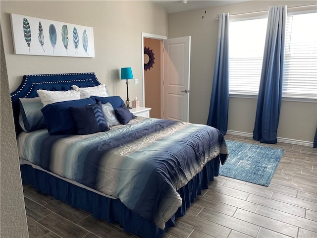 bedroom with wood tiled floor and baseboards