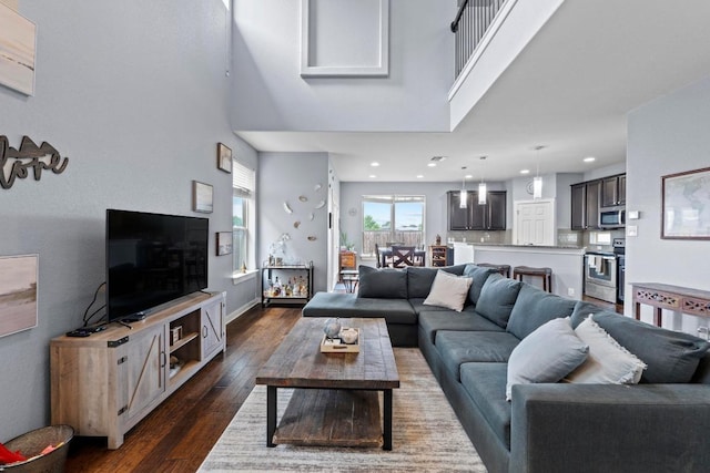 living area featuring dark wood-type flooring and recessed lighting