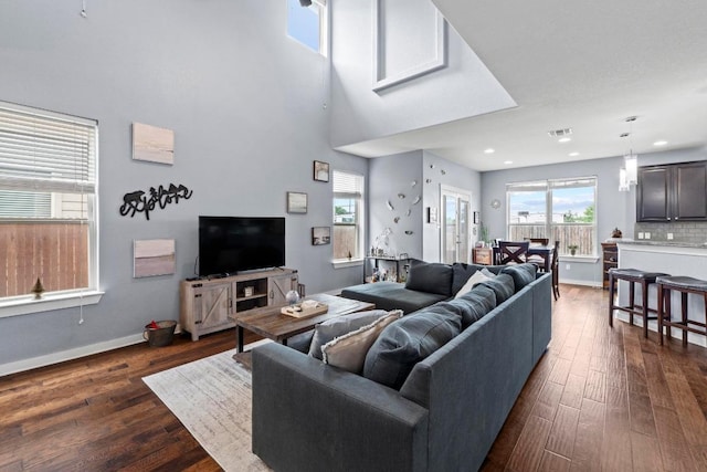 living room featuring recessed lighting, baseboards, dark wood finished floors, and visible vents