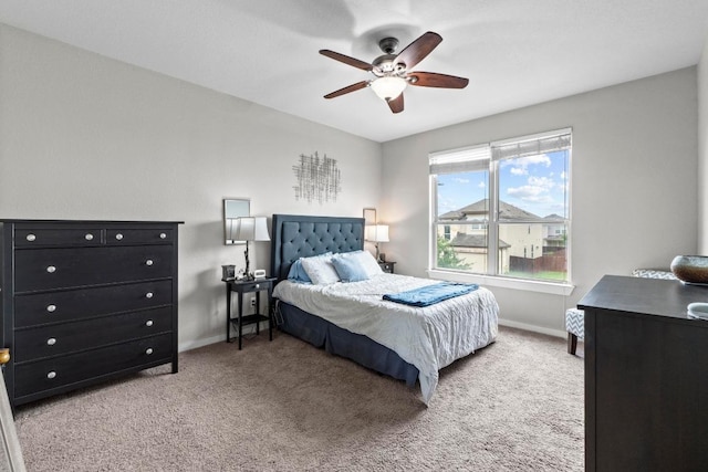bedroom featuring baseboards, ceiling fan, and carpet floors