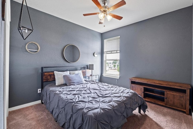 carpeted bedroom with baseboards and a ceiling fan