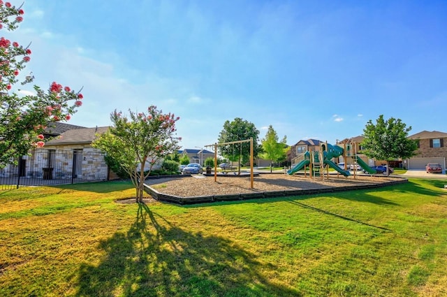 community jungle gym with fence and a yard