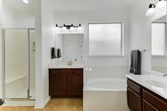 240 Fort Mabry Loop, Georgetown, TX 78628 - full bathroom featuring two vanities, a sink, a garden tub, and a stall shower
