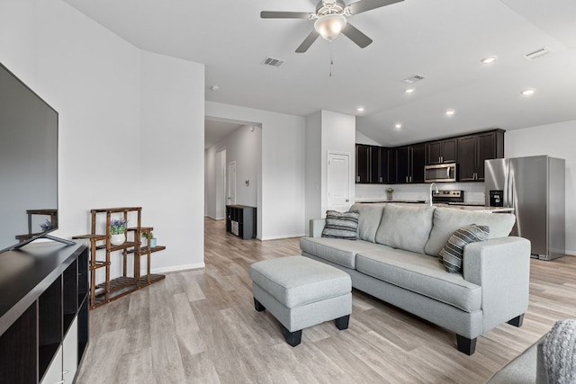 216 Pearland St, Hutto, TX 78634 - living area featuring light wood-type flooring, ceiling fan, lofted ceiling, and visible vents