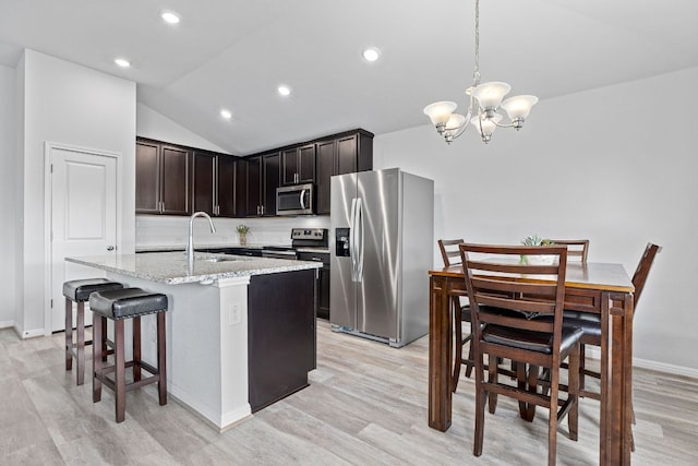 216 Pearland St, Hutto, TX 78634 - kitchen with light wood-type flooring, a sink, appliances with stainless steel finishes, and light stone countertops