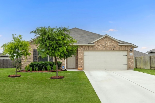 216 Pearland St, Hutto, TX 78634 - view of front of house featuring concrete driveway, brick siding, fence, and a front lawn