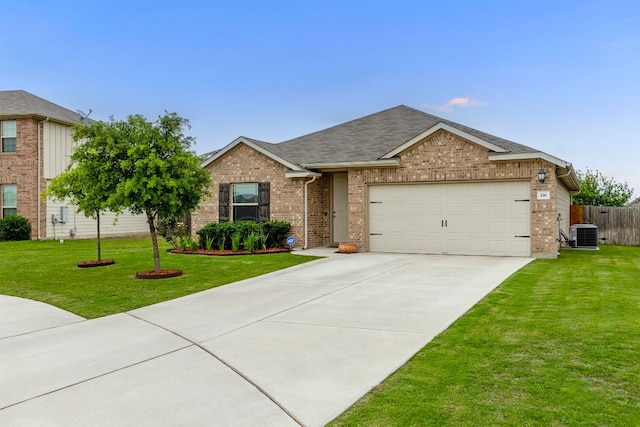 216 Pearland St, Hutto, TX 78634 - single story home with a front yard, a garage, central air condition unit, brick siding, and concrete driveway