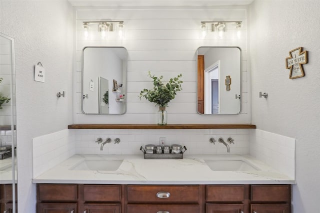 bathroom featuring double vanity and a sink
