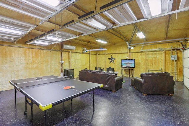 playroom featuring a garage and a wall unit AC