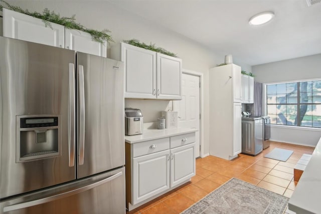 2858 Cedar Hollow Rd, Georgetown, TX 78628 - kitchen featuring stainless steel refrigerator with ice dispenser, white cabinets, washing machine and dryer, and light tile patterned floors