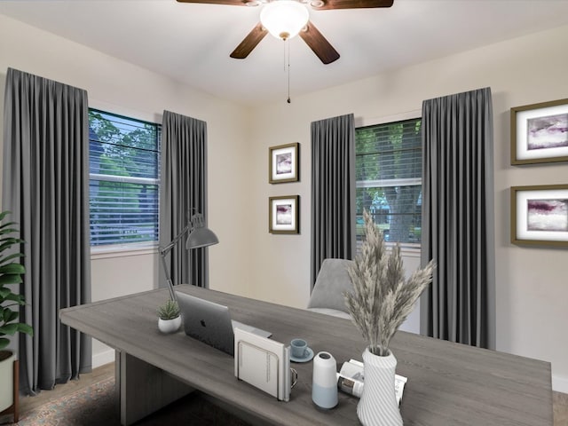 dining area featuring baseboards and ceiling fan