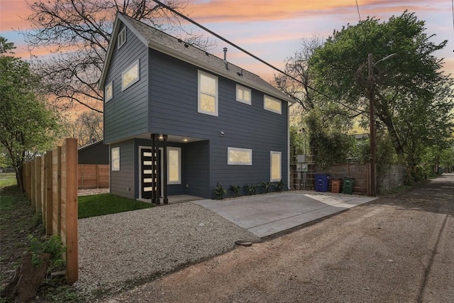 back of house at dusk with fence