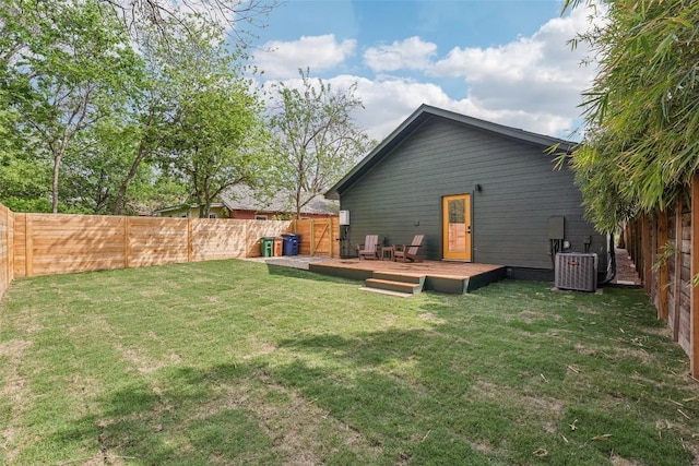 back of house featuring a yard, a deck, central AC, and a fenced backyard