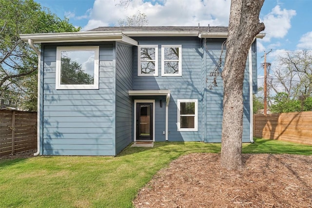 view of front of house with a fenced backyard and a front yard