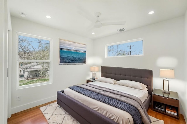 bedroom featuring recessed lighting, a ceiling fan, visible vents, and wood finished floors