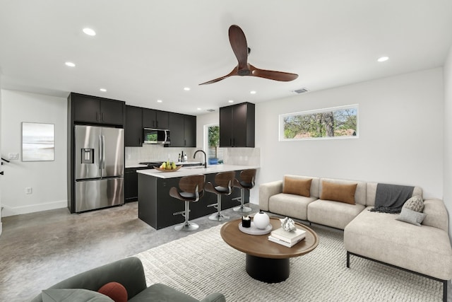 living area with baseboards, plenty of natural light, recessed lighting, and visible vents