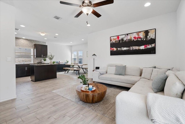9015 Looksee Ln, Austin, TX 78744 - living area with visible vents, recessed lighting, light wood-style floors, and a ceiling fan