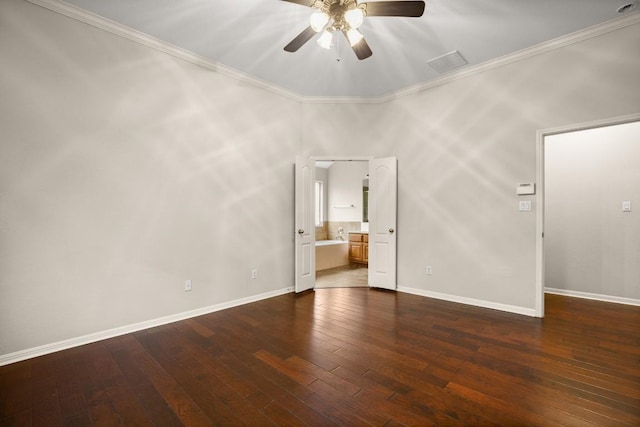 empty room with ceiling fan, dark wood finished floors, baseboards, visible vents, and ornamental molding