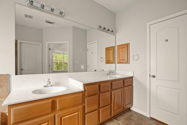 full bathroom featuring a sink, double vanity, and visible vents