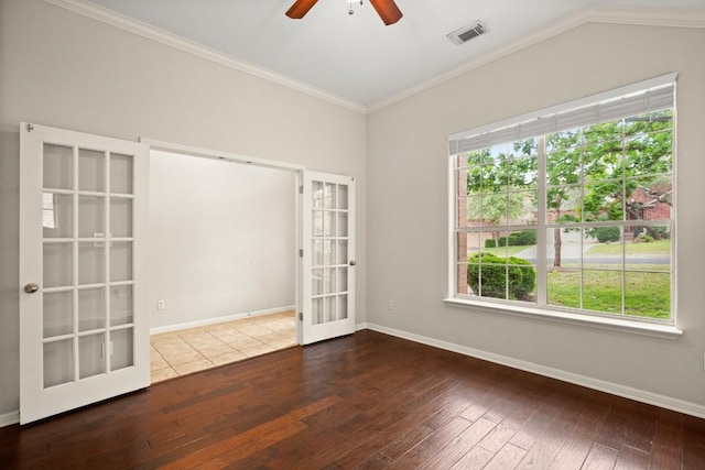 empty room featuring ceiling fan, french doors, hardwood / wood-style flooring, and visible vents