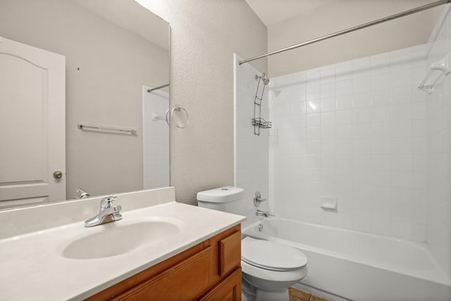 bathroom featuring vanity, a textured wall, toilet, and tub / shower combination