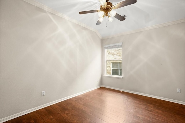 spare room featuring baseboards, ceiling fan, ornamental molding, and wood finished floors