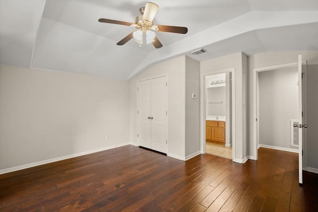 unfurnished bedroom with ceiling fan, visible vents, hardwood / wood-style flooring, baseboards, and lofted ceiling