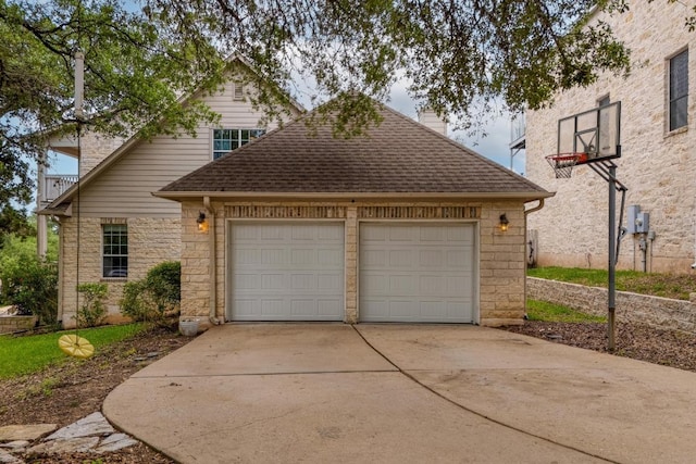 view of front facade with a chimney, concrete driveway, an attached garage, a shingled roof, and stone siding