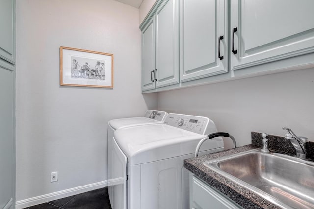 laundry room featuring washer and dryer, dark tile patterned floors, a sink, and cabinet space