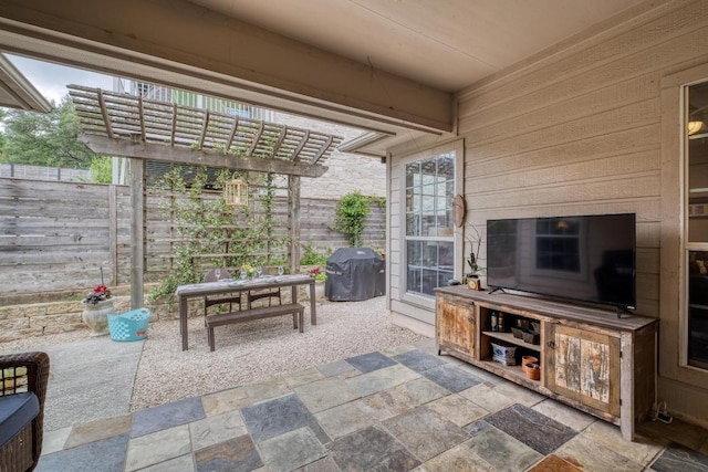 view of patio / terrace with fence, a pergola, and grilling area