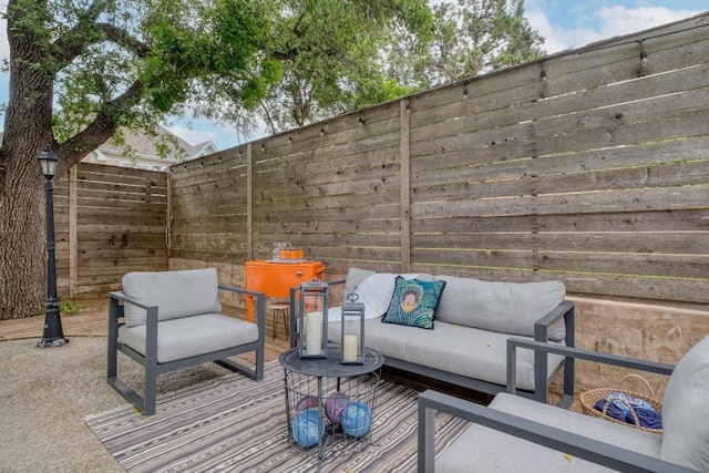exterior space featuring an outdoor living space and fence