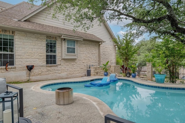 view of pool featuring a fenced in pool, fence, and a patio
