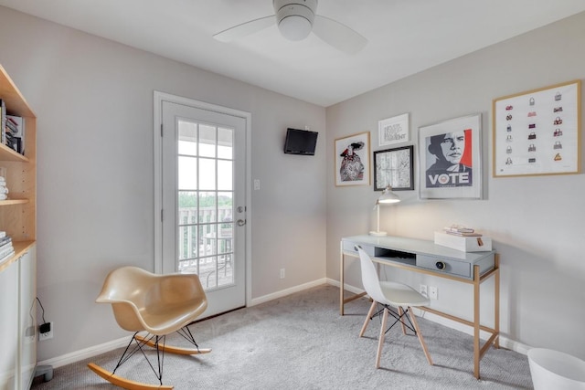 home office featuring carpet flooring, a ceiling fan, and baseboards