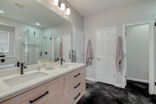bathroom featuring a sink, a shower stall, double vanity, and visible vents