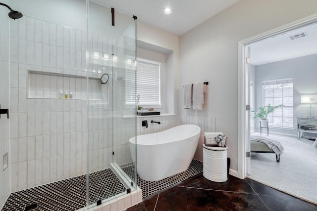 4511 Heights Dr, Austin, TX 78746 - ensuite bathroom with a stall shower, tile walls, a freestanding bath, recessed lighting, and tile patterned flooring
