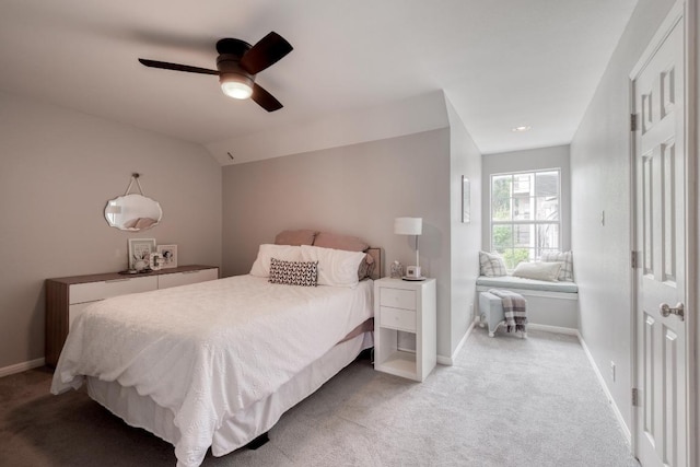 bedroom with baseboards, light carpet, ceiling fan, and lofted ceiling