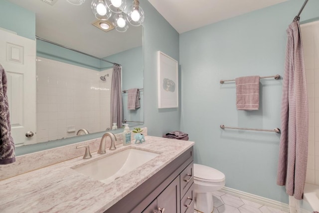 bathroom with vanity, toilet, baseboards, a shower with shower curtain, and tile patterned floors